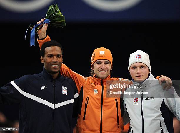 Shani Davis of the United States wins the silver, Mark Tuitert of Netherlands the gold and Havard Bokko of Norway the bronze medal during the flower...