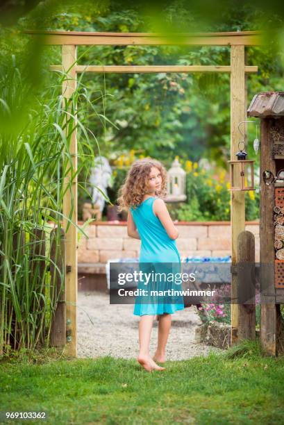 little girl in the garden under a japanese gate - martinwimmer stock pictures, royalty-free photos & images