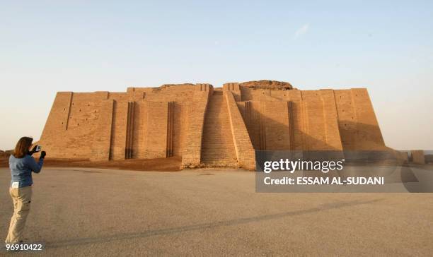 Iraq-archaeology-tourism,FEATURE, by Mehdi Lebouachera A visitor takes pictures of the stepped Ziggurat temple, a three-tiered edifice dating back to...