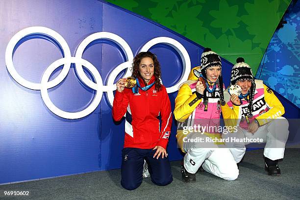 Amy Williams of Great Britain and Northern Ireland receives the gold medal as Anja Huber of Germany and Kerstin Szymkowiak of Germany receive the...