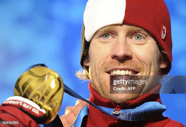 Canada's gold medalist Jon Montgomery celebrates on the podium during the medal ceremony of the men's skeleton final event of the Vancouver Winter...