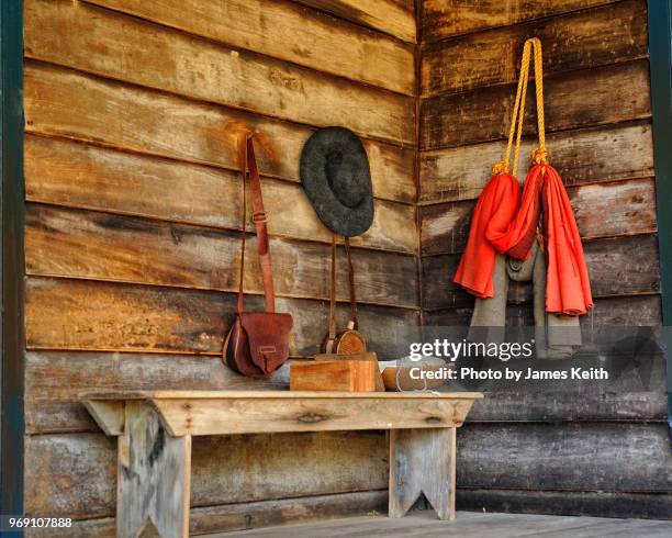 the back stoop of a log cabin with items of the frontier era hanging on the walls. - natchez trace parkway stock pictures, royalty-free photos & images