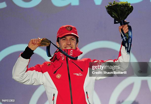 Simon Ammann of Switzerland receives the gold medal during the medal ceremony for the men's large hill individual ski jumping held at the Whistler...