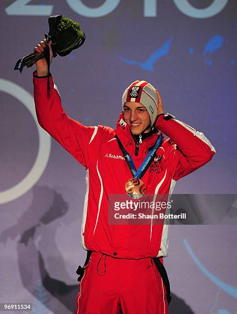 Gregor Schlierenzauer of Austria receives the bronze medal during the medal ceremony for the men's large hill individual ski jumping held at the...