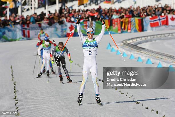 Marcus Hellner of Sweden celebrates his victory over Tobias Angerer of Germany during the men's 30km pursuit at the Olympic Winter Games Vancouver...