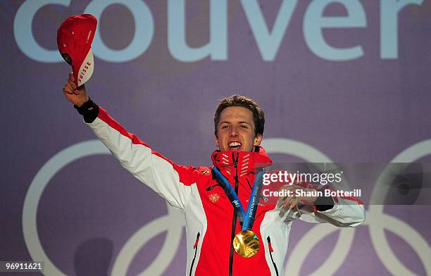 Simon Ammann of Switzerland receives the gold medal during the medal ceremony for the men's large hill individual ski jumping held at the Whistler...