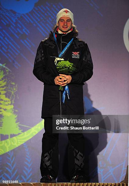 Martins Dukurs of Latvia receives the silver medal during the medal ceremony for the men's skeleton held at the Whistler Medals Plaza on day 9 of the...