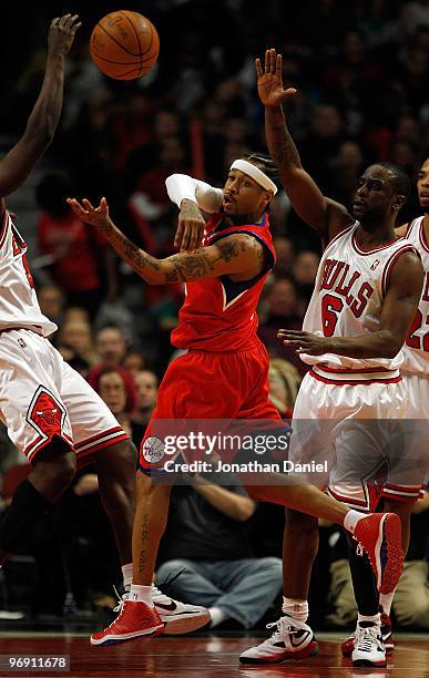 Allen Iverson of the Philadelphia 76ers passes the ball under pressure from Ronald Murray of the Chicago Bulls at the United Center on February 20,...