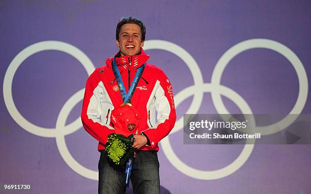 Simon Ammann of Switzerland receives the gold medal during the medal ceremony for the men's large hill individual ski jumping held at the Whistler...