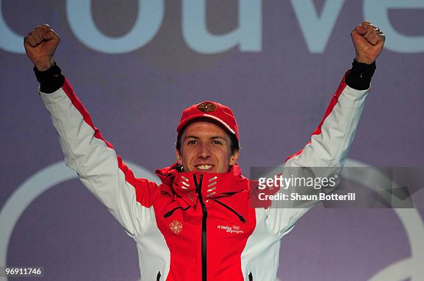 Simon Ammann of Switzerland receives the gold medal during the medal ceremony for the men's large hill individual ski jumping held at the Whistler...