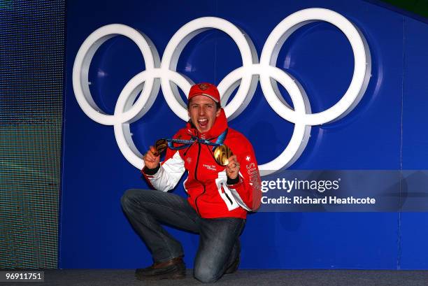 Simon Ammann of Switzerland receives the gold medal during the medal ceremony for the men's large hill individual ski jumping held at the Whistler...