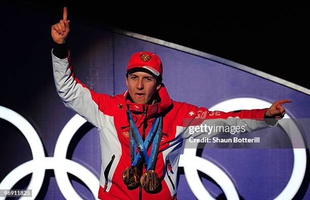 Simon Ammann of Switzerland receives the gold medal during the medal ceremony for the men's large hill individual ski jumping held at the Whistler...