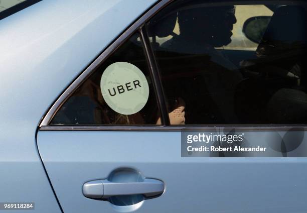 An Uber driver and car with passengers in Washington, D.C.