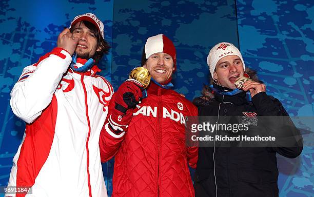 Alexander Tretyakov of Russia receives the bronze medal, Jon Montgomery of Canada receives the gold medal and Martins Dukurs of Latvia receives the...