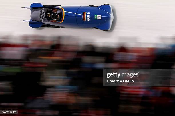 Thomas Florschuetz and Richard Adjei of Germany-two compete in the men's bobsleigh two-man heats on day 9 of the 2010 Vancouver Winter Olympics at...