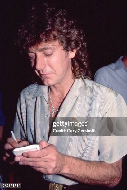 British Rock musician Robert Plant signs an autograph at an after party at Greenwich Village's Be Bop Club, New York, New York, September 12, 1983....