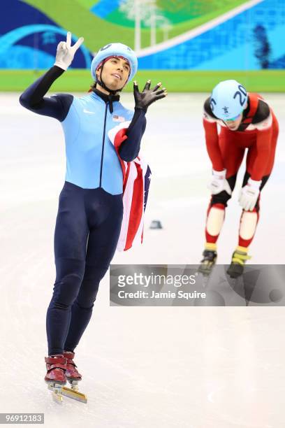 Apolo Anton Ohno of the United States holds up seven fingers to signify his seven Olympic medals after winning bronze during the Short Track Speed...