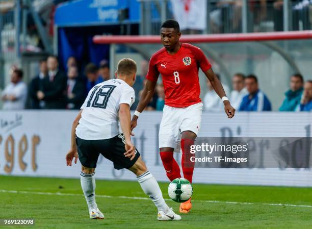 Joshua Kimmich of Germany and David Alaba of Austria battle for the ball during the international friendly match between Austria and Germany at...