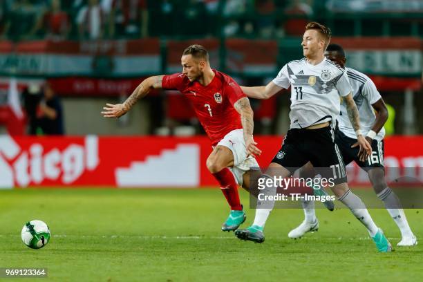 Marko Arnautovic of Austria and Marco Reus of Germany battle for the ball during the international friendly match between Austria and Germany at...