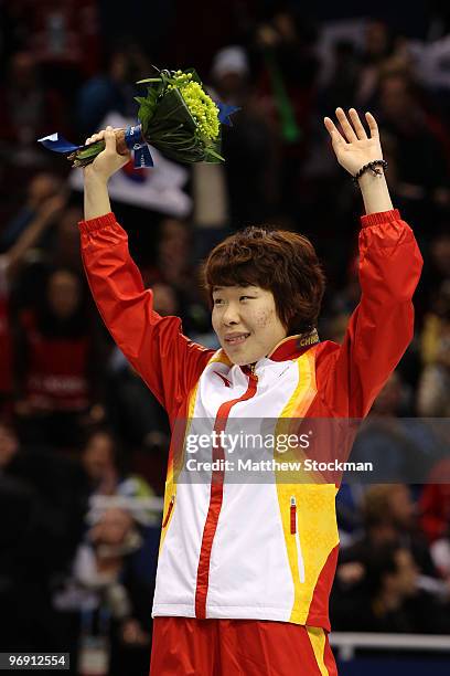 Zhou Yang of China celebrates winning the gold medal during the flower ceremony for the women's 1500 m short track on day 9 of the Vancouver 2010...