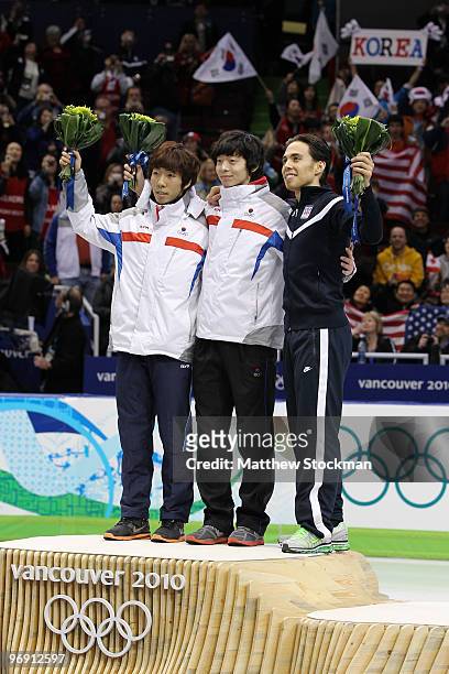 Lee Ho-Suk of South Korea celebrates winning silver, Lee Jung-Su of South Korea gold and Apolo Anton Ohno of the United States bronze during the...