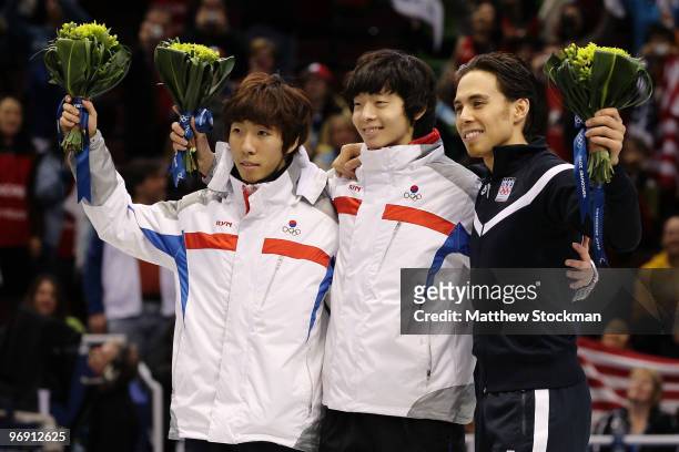 Lee Ho-Suk of South Korea celebrates winning silver, Lee Jung-Su of South Korea gold and Apolo Anton Ohno of the United States bronze during the...