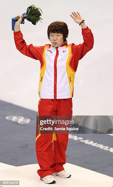 Zhou Yang of China celebrates winning the gold medal during the flower ceremony for the women's 1500 m short track on day 9 of the Vancouver 2010...