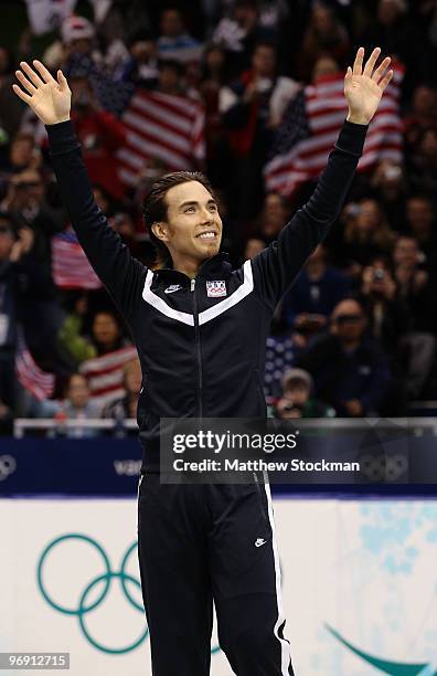 Apolo Anton Ohno of the United States celebrates winning the bronze medal during the flower ceremony for the men's 1000 m short track speed skating...