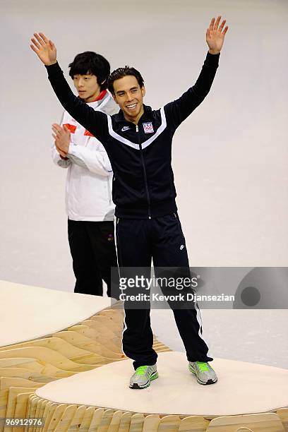 Apolo Anton Ohno of the United States celebrates winning the bronze medal during the flower ceremony for the men's 1000 m short track speed skating...
