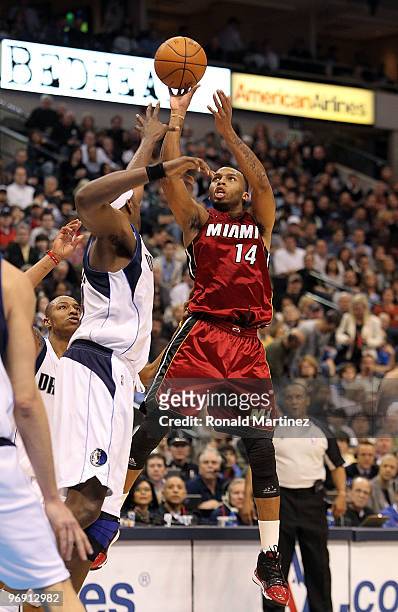 Guard Daequan Cook of the Miami Heat takes a shot against Brendan Haywood of the Dallas Mavericks on February 20, 2010 at American Airlines Center in...