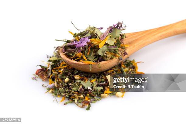 dried herbal flower tea leaves over white background - theeblaadjes stockfoto's en -beelden