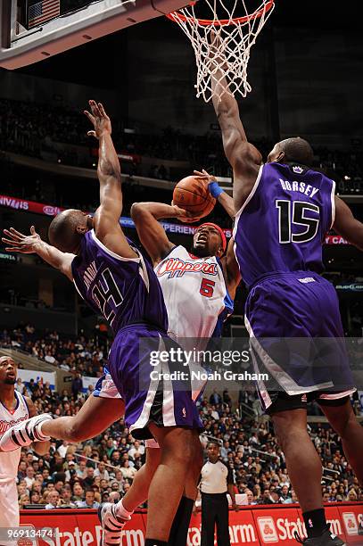 Craig Smith of the Los Angeles Clippers goes up for a shot between Carl Landry and Joey Dorsey of the Sacramento Kings at Staples Center on February...