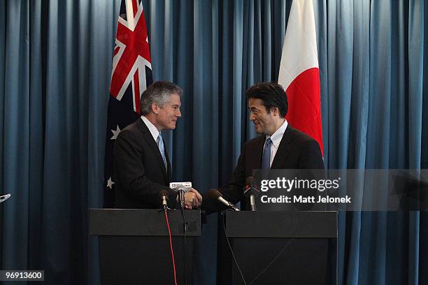 Australian Minister for Foreign Affairs Stephen Smith shakes hands with Japan's Minister For Foreign Affairs Katsuya Okada at a press conference at...