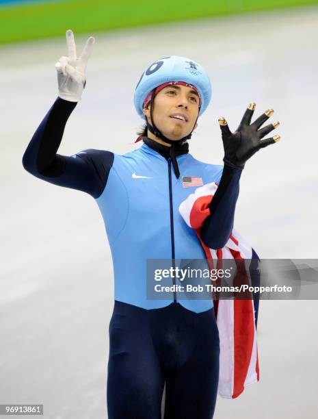 Apolo Anton Ohno of the United States holds up seven fingers to signify his seven Olympic medals after winning bronze during the Short Track Speed...