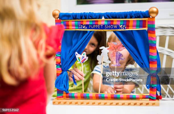 back view girk looking puppet show that play her brother and sister - puppet theatre stock pictures, royalty-free photos & images