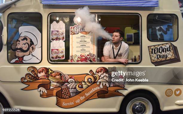 Vendor vapes in a converted ice cream van during the Vape Jam UK 4 at ExCel on April 6, 2018 in London, England. Vape Jam UK, the premier Electronic...