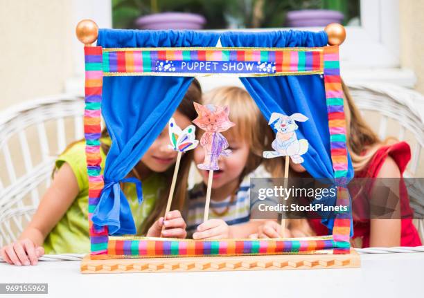 three cute child playing with marionettes made of paper - actors at home stock pictures, royalty-free photos & images