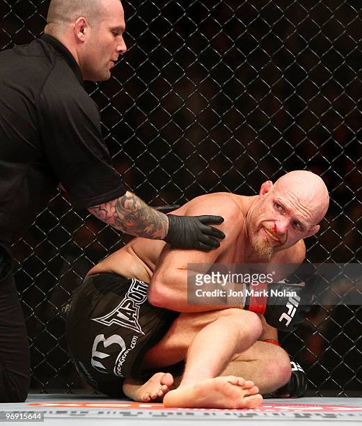 Fighter Keith Jardine is assisted after being knocked down by UFC fighter Ryan Bader during their Ultimate Fighting Championship light-heavyweight...