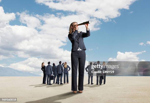 one businesswoman stands out from a group and searches for a solution - moral compass stock pictures, royalty-free photos & images