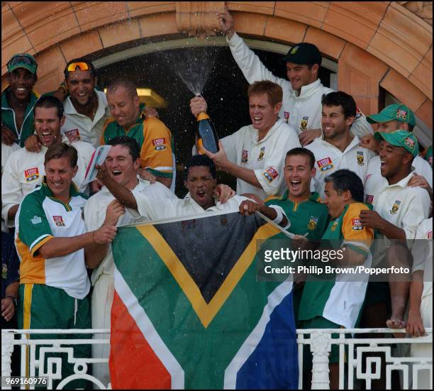 The South Africa players and staff celebrate on the dressing room balcony after winning the 2nd Test match against England by an innings and 92 runs...