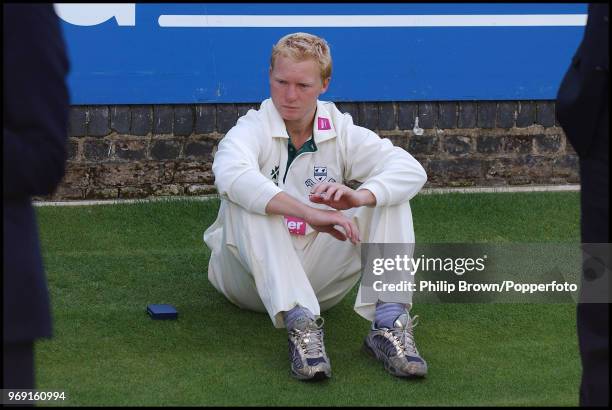 Dejected Gareth Batty of Worcestershire sits on the pitch in front of the pavilion during the presentation ceremony after the Cheltenham and...