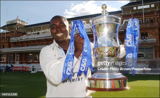 Gloucestershire captain Mark Alleyne poses with the trophy after Gloucestershire won the Cheltenham and Gloucester Trophy Final against...