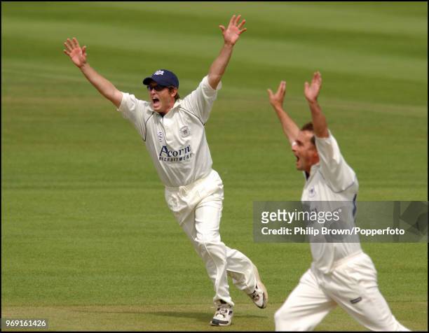 Ian Harvey and Mike Smith of Gloucestershire celebrate after Ian Bell of Warwickshire was run out by a direct hit from Harvey during the C&G Trophy...