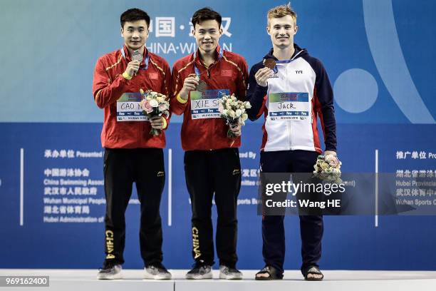 Silver medallist Cao Yuan of China ,gold medallist Xie Siyi of China and Bronze medallist Jack Laugher of Great Britain during the medal ceremony for...