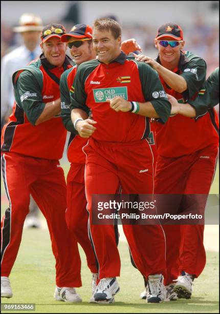 Heath Streak of Zimbabwe is congratulated after getting the wicket of England batsman Marcus Trescothick during the 1st NatWest Series One Day...