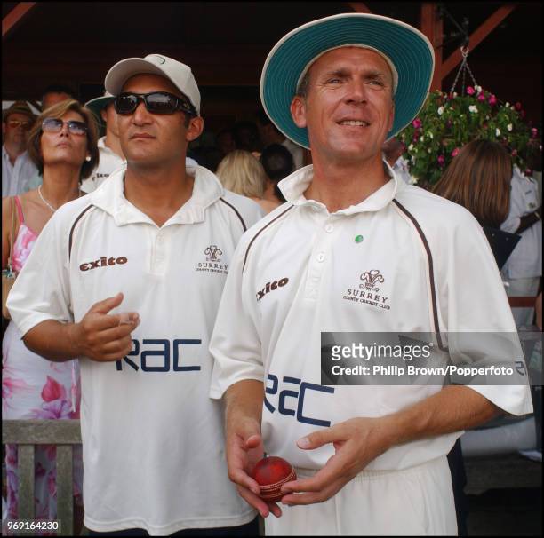 Surrey and England cricketers Mark Butcher and Alec Stewart prepare to take the field during a Bunbury Cricket Club cricket match at Ripley, Surrey,...