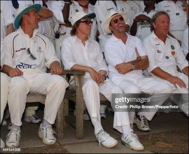 Alec Stewart, Bill Wyman, Eric Clapton and David English get ready for the team photo during a Bunbury Cricket Club charity cricket match at Ripley,...