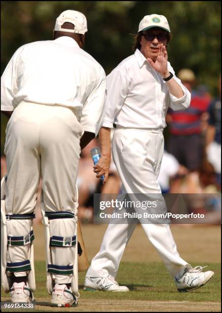 Bill Wyman gives some advice to Viv Richards during a Bunbury Cricket Club charity cricket match at Ripley, Surrey, 10th August 2003.