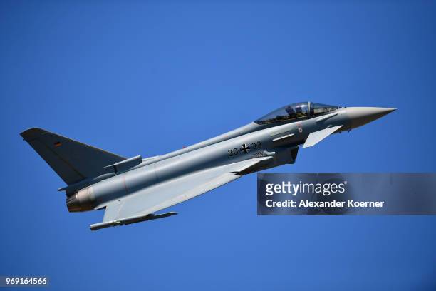 An Eurofighter Typhoon jet performs at Fliegerhorst Wunstorf to take part in an open house day of the Bundeswehr on June 7, 2018 in Wunstorf,...