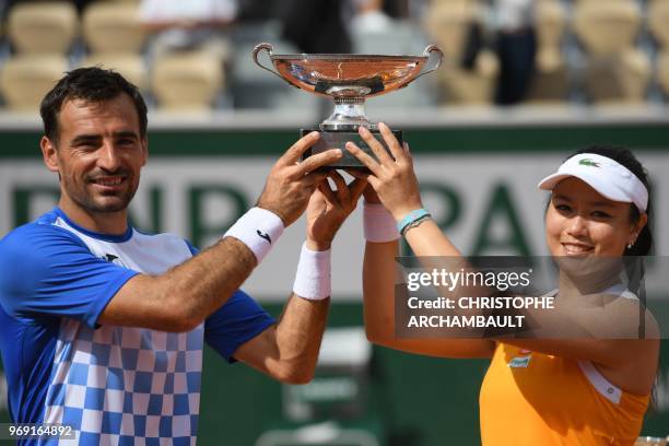 Taiwan's Latisha Chan and Croatia's Ivan Dodig pose with the trophy after their victory over Canada's Gabriela Dabrowski and Croatia's Mate Pavic in...